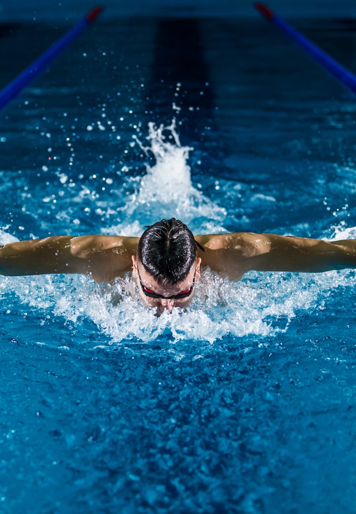 Swimmer mid-stroke in a pool lane